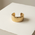 Hammered gold-vermeil cuff bracelet on paper