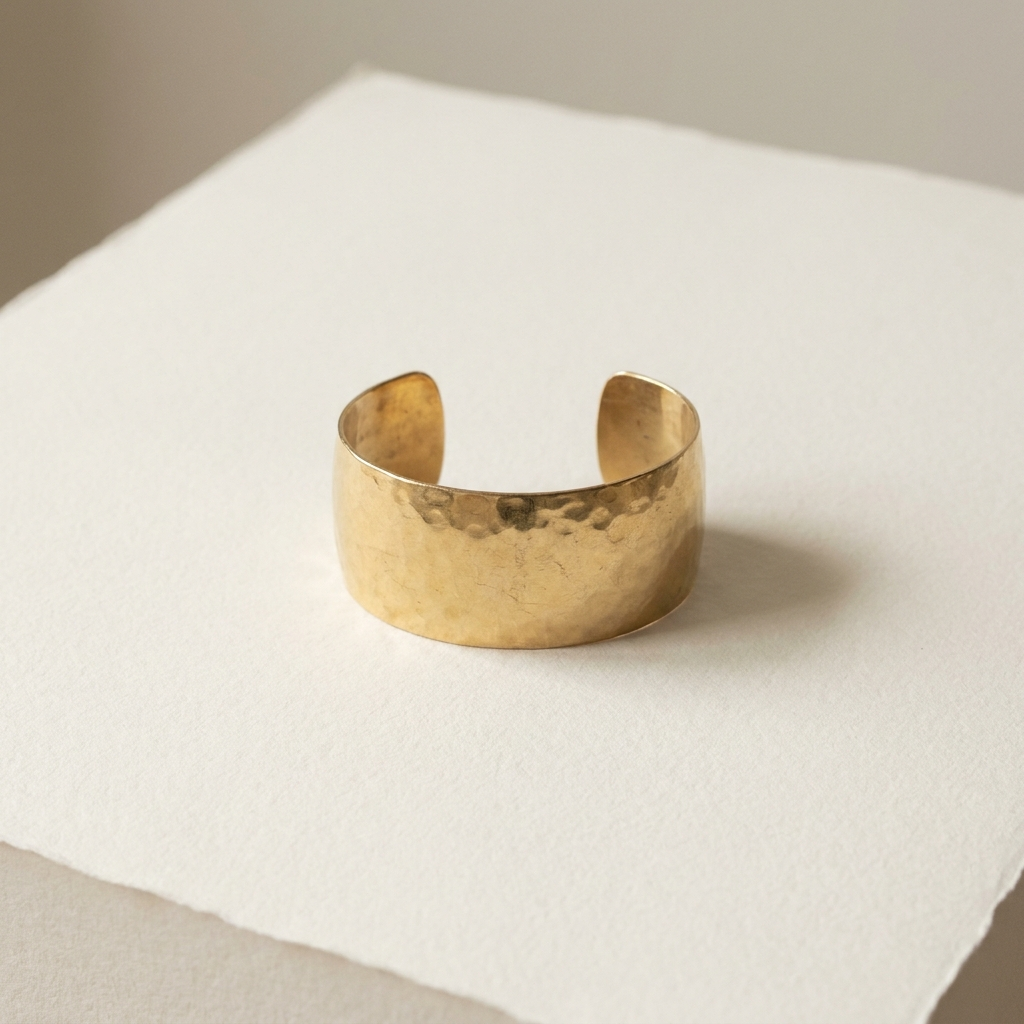 Hammered gold-vermeil cuff bracelet on paper