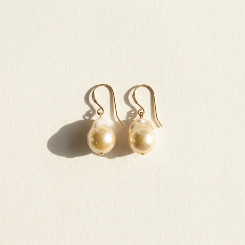 Baroque pearl drop earrings on paper
