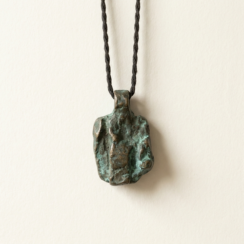 Brutalist bronze pendant with verdigris patina on cord